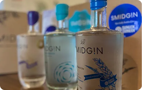 Three Smidgin bottles with custom-coloured wax seals and personalised labels